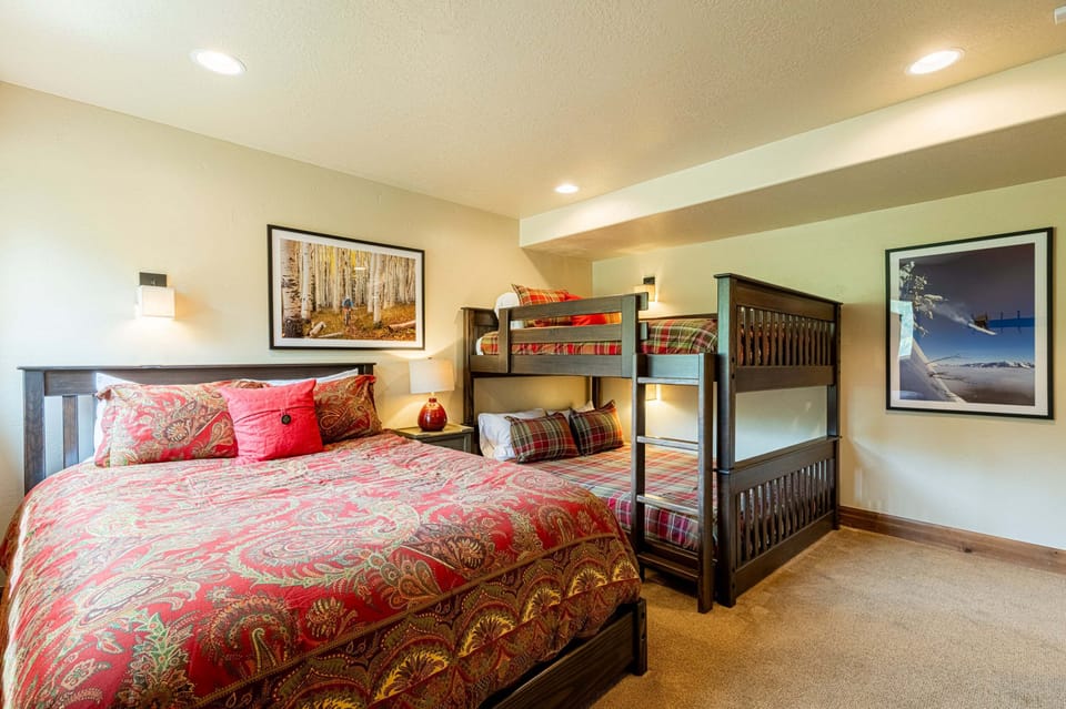 1st level Bedroom 4 with a queen bed and queen over queen bunk beds and private bath
