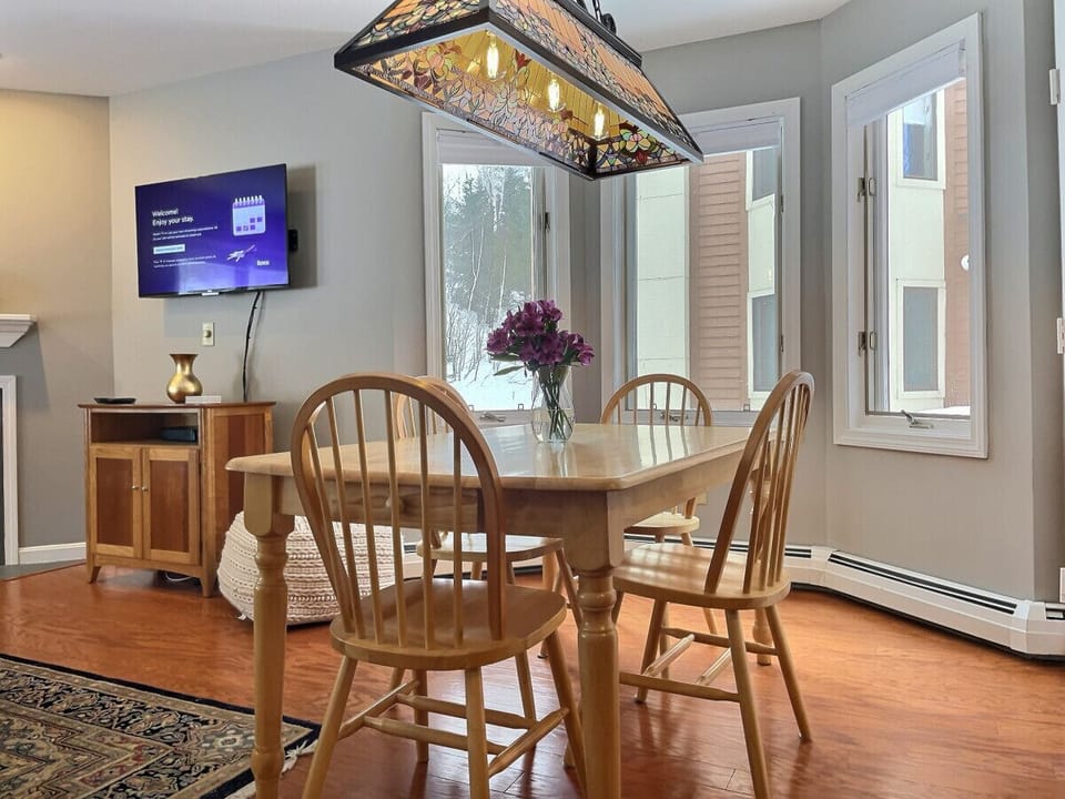 Experience the charming ambiance of our table adorned with lights and the beautiful outdoor view