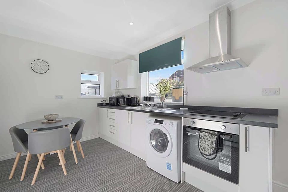 Kitchen equipped with all essentials, including a washer & dryer, oven, fridge and full cookware set.
