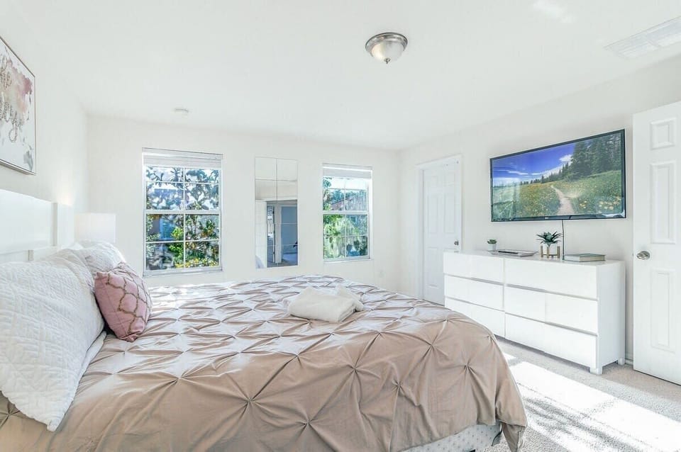 Spacious master bedroom with king bed, soft bedding, and an inviting atmosphere.