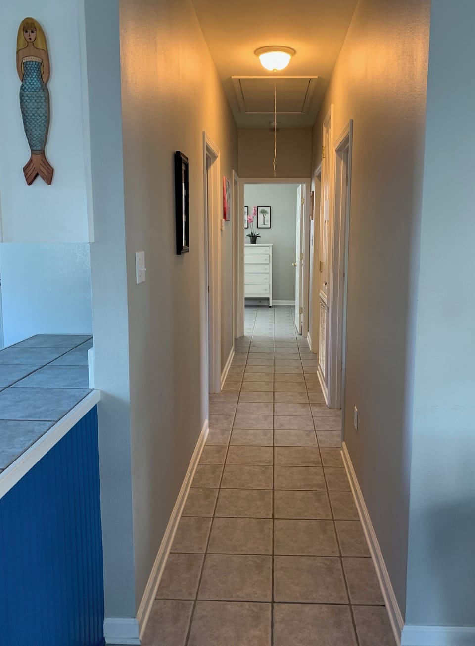A short hallway leads back to the 3 bedrooms, bathrooms, and laundry room.