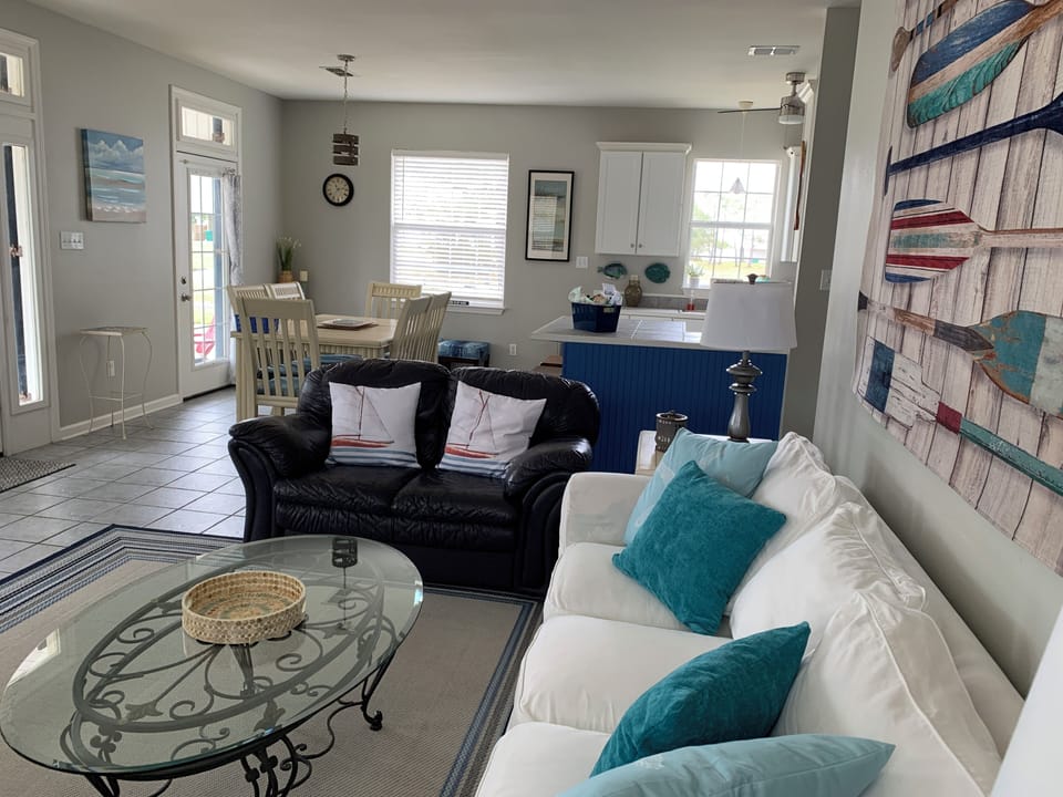 The airy living room has plenty of seating for all.