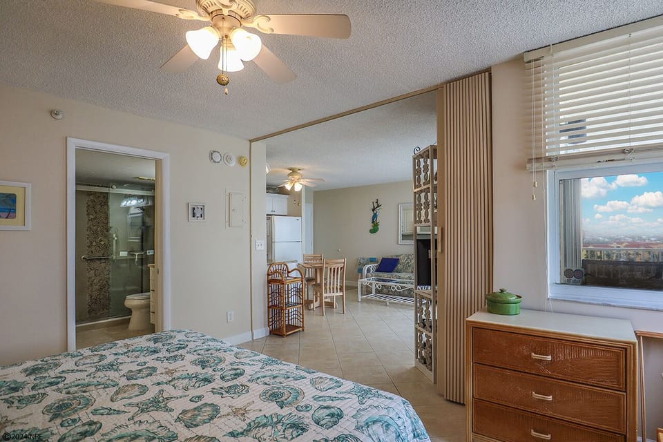 Bedroom has a folding partition to divide the bedroom from the living area