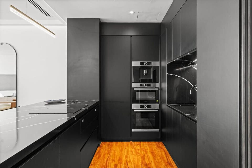 Sleek Kitchen: Enjoy culinary adventures in this chic black-and-wood culinary haven!