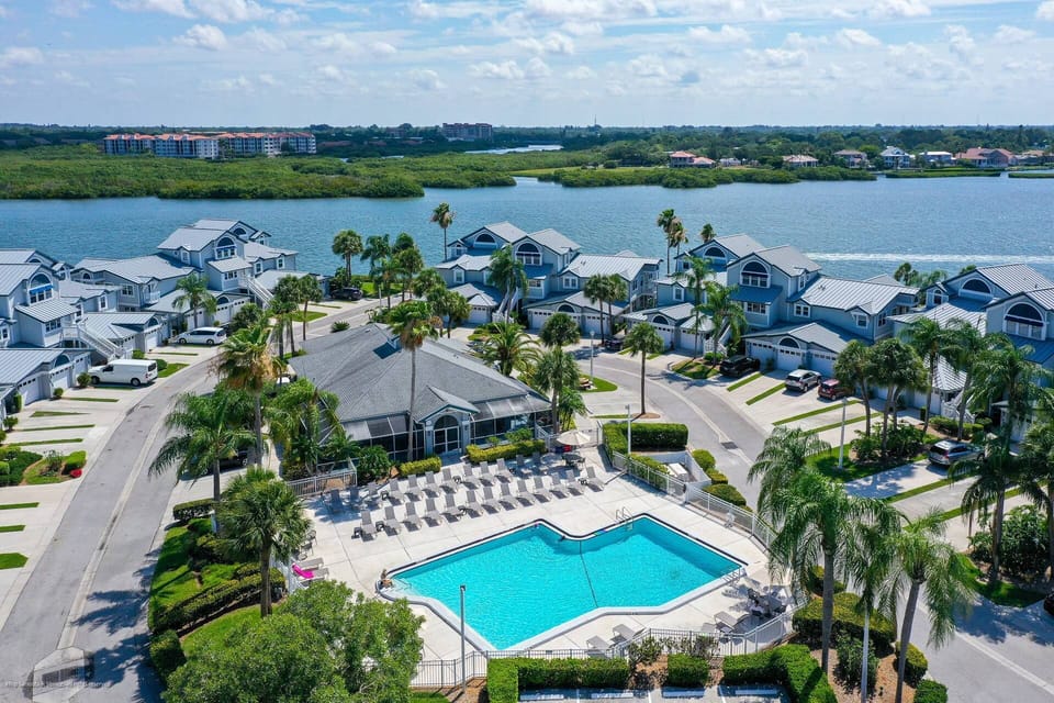 Aerial view of the large community heated pool next to the bay