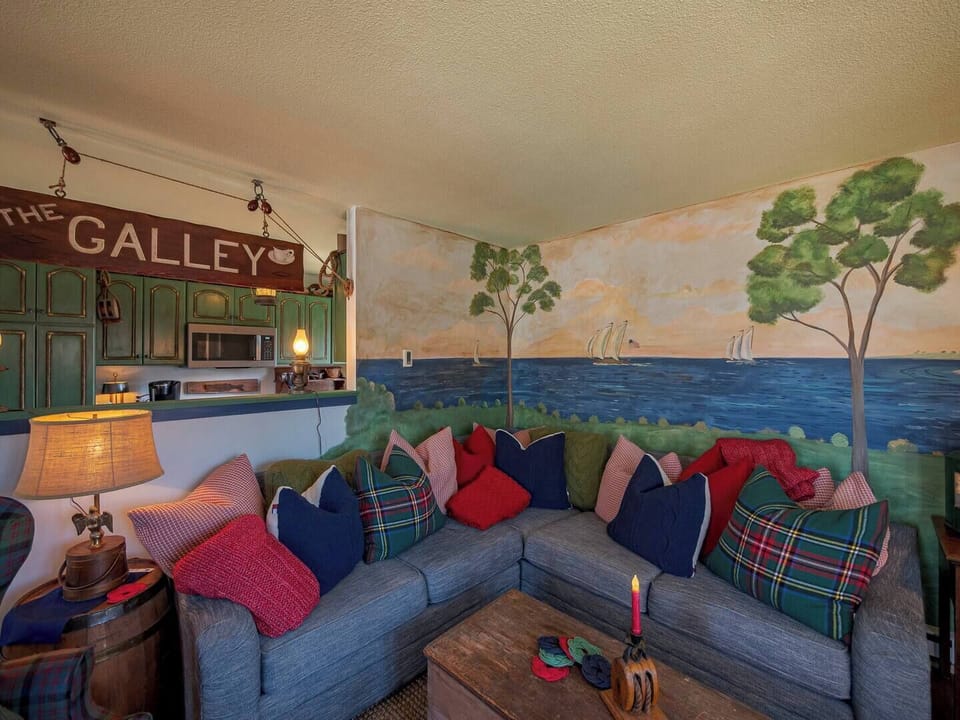 The galley kitchen and living room in the 2nd floor Chandler's Apartment offer lots of time together, whether you're the chef cooking or the one relaxing on the couch nestled in with a Susan Leach mural, it's quality time spent together!