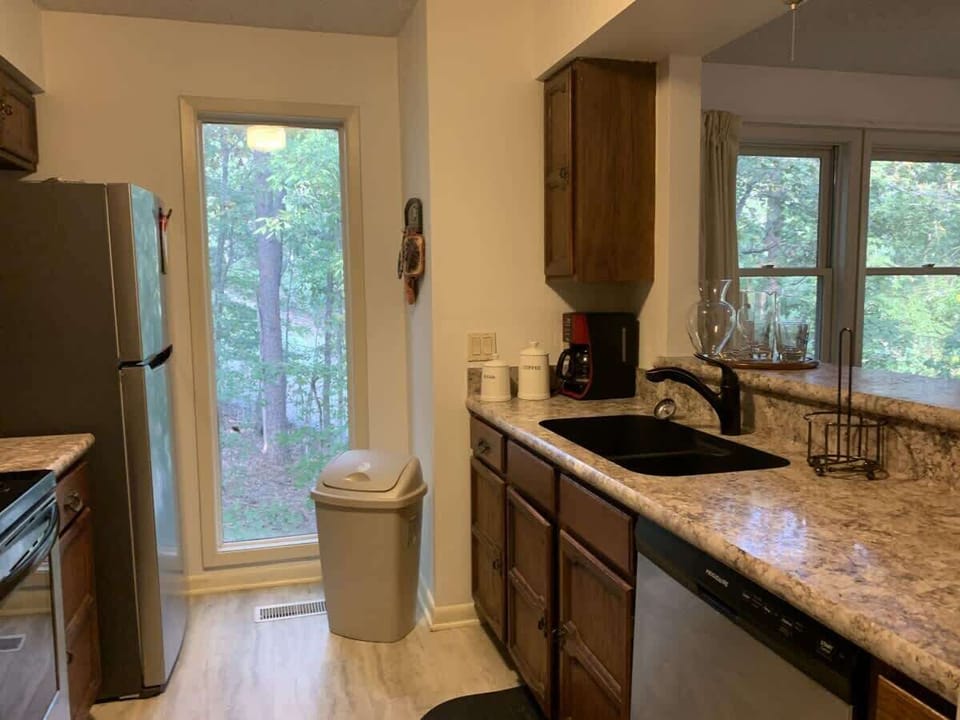 Fully equipped kitchen with all major appliances and a beautiful forest backdrop — perfect for extended stays.