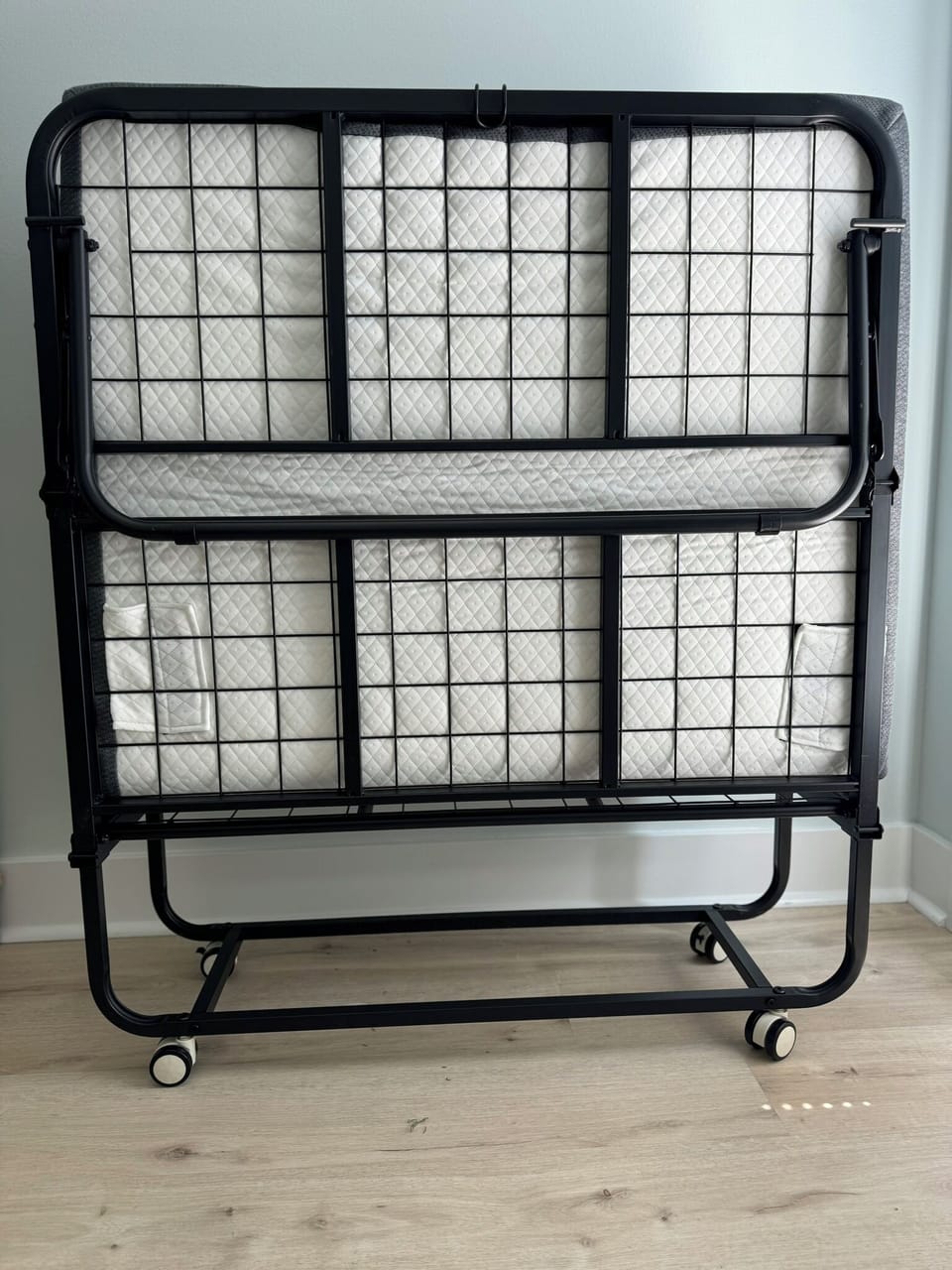 38" rollaway bed in master suite with linens, pillows and blanket.