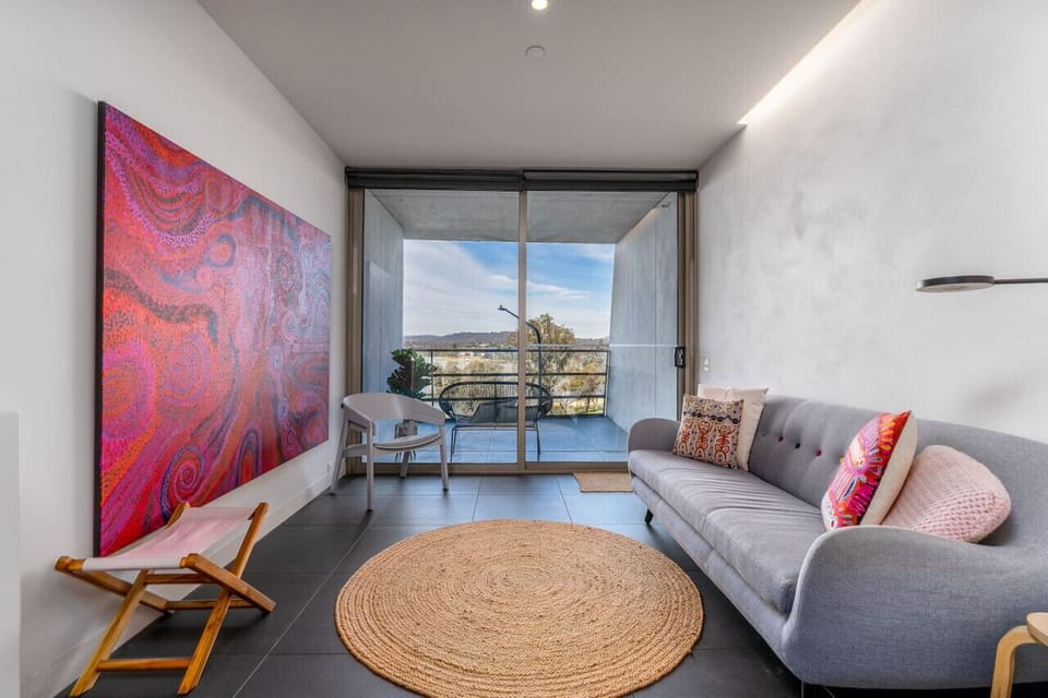 Relax in the light-filled lounge area, designed for seamless indoor-outdoor living.