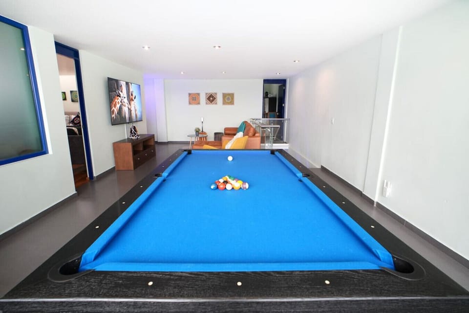 Custom full size pool table with sweeping views of the city. Unique architectural dome that lights up at night to provide added atmosphere.  Enjoy a drink around the table as you watch the sunset or put the game on the 75` 4K smart TV.