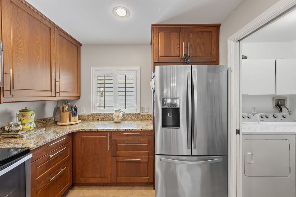 The laundry room is right off the kitchen inside the residence