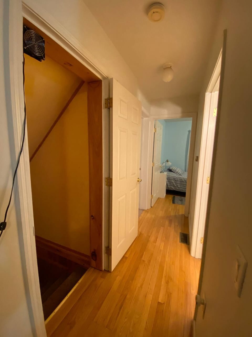 Hallway on Main floor. Stairs from basement on the left. Bathroom 2 on the right