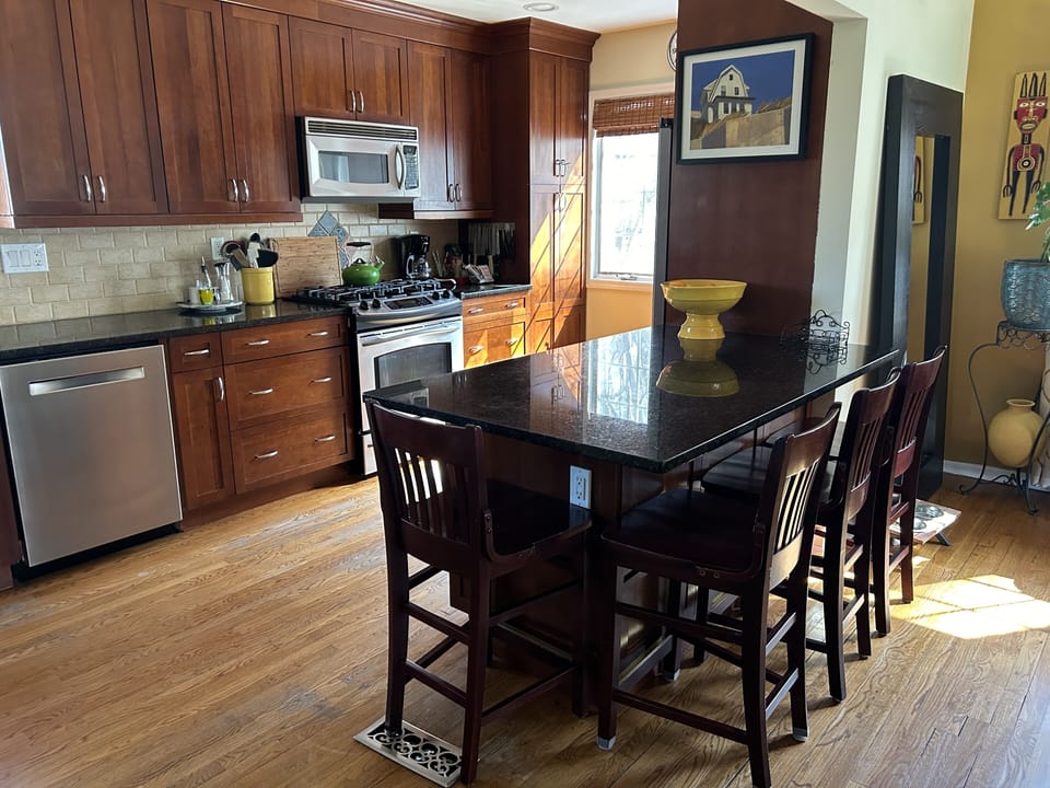 Galley kitchen with counter table opens into the dining room.