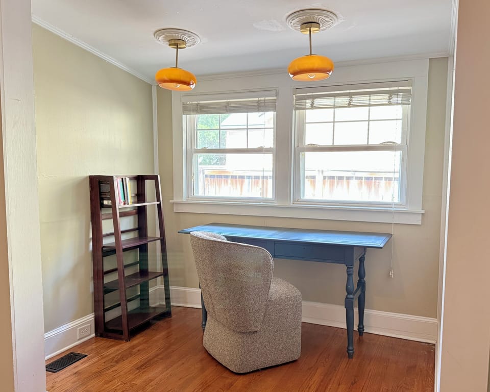Sunny dedicated workspace with hardwood floors and charming vintage lighting