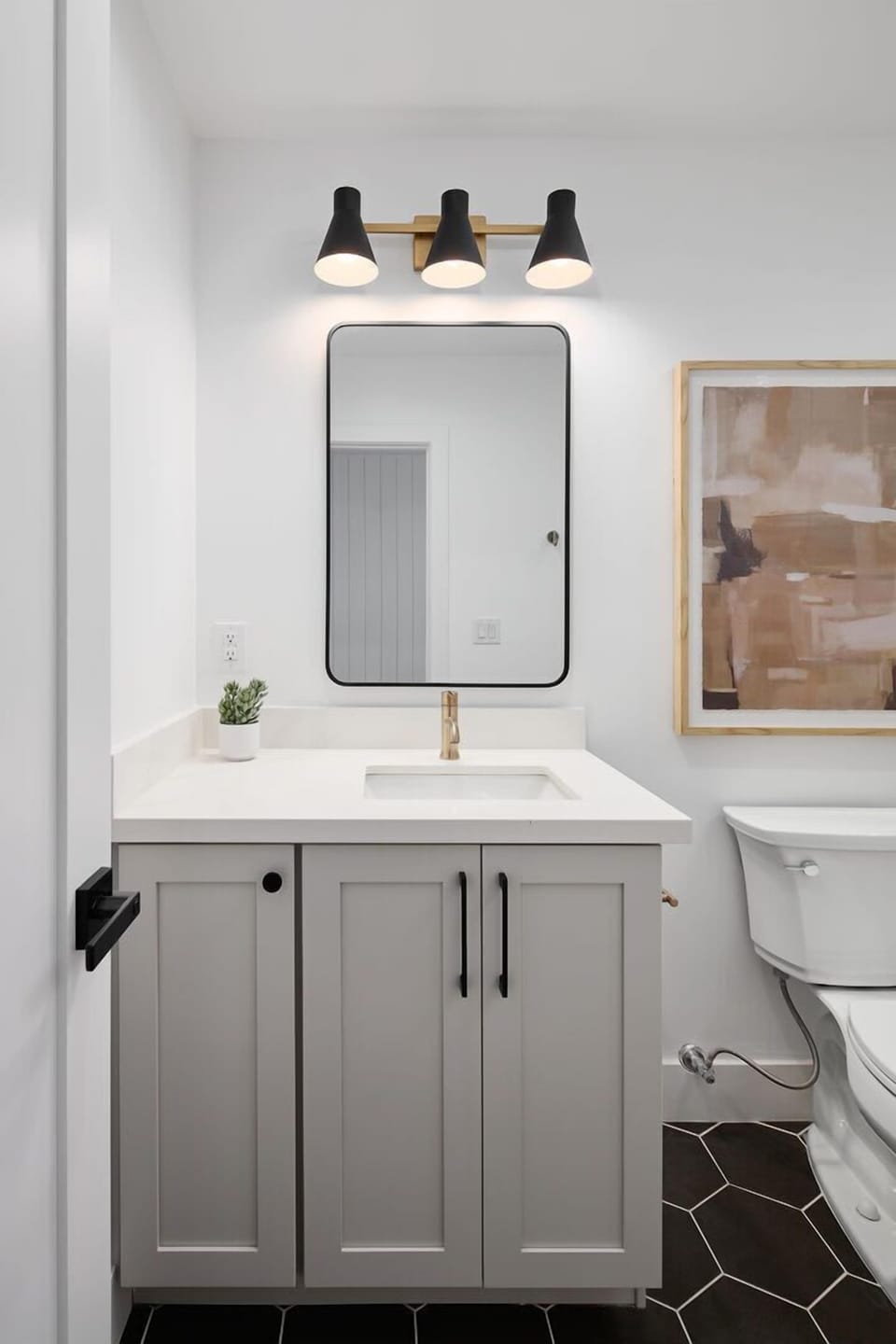 Full hallway bathroom off the living area featuring a single vanity and a luxurious stand-in shower.