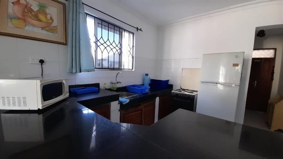 Comfort Apartment | Private kitchen | Fridge, microwave, cookware/dishes/utensils, dining tables
