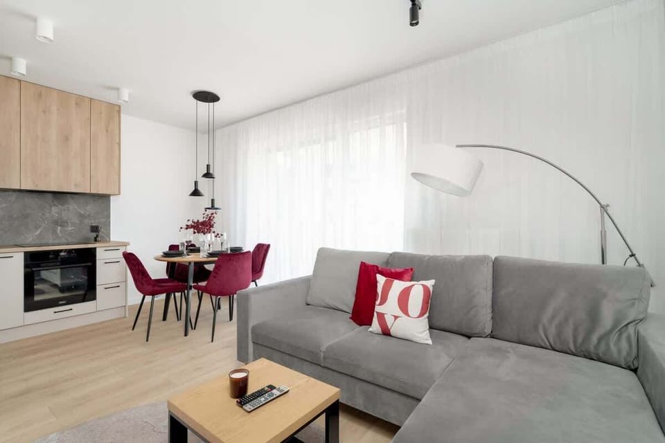 A view showing part of the living room and hallway, with wooden flooring and modern decor.