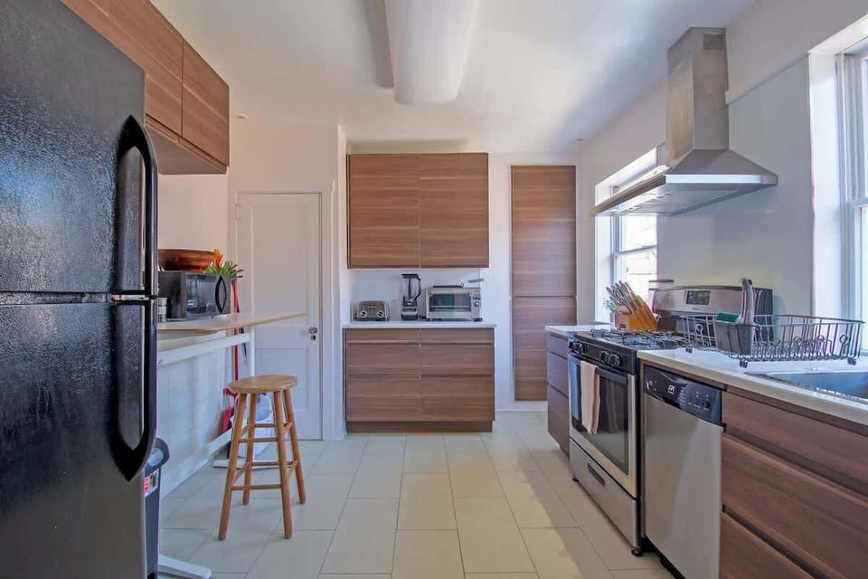 Newly renovated fully stocked kitchen with tons of natural light, gas range, dishwasher. 