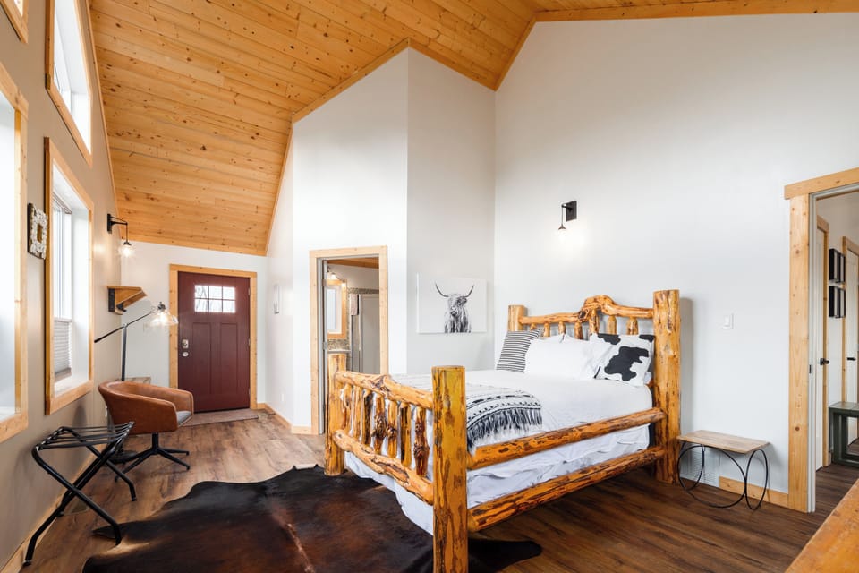 Custom log bed with massive ceilings and large mountain facing windows