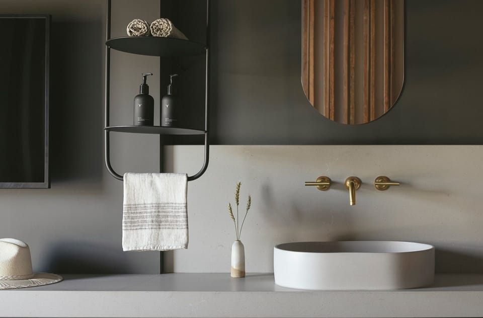 Start mornings at a sleek vanity with warm brass accents.