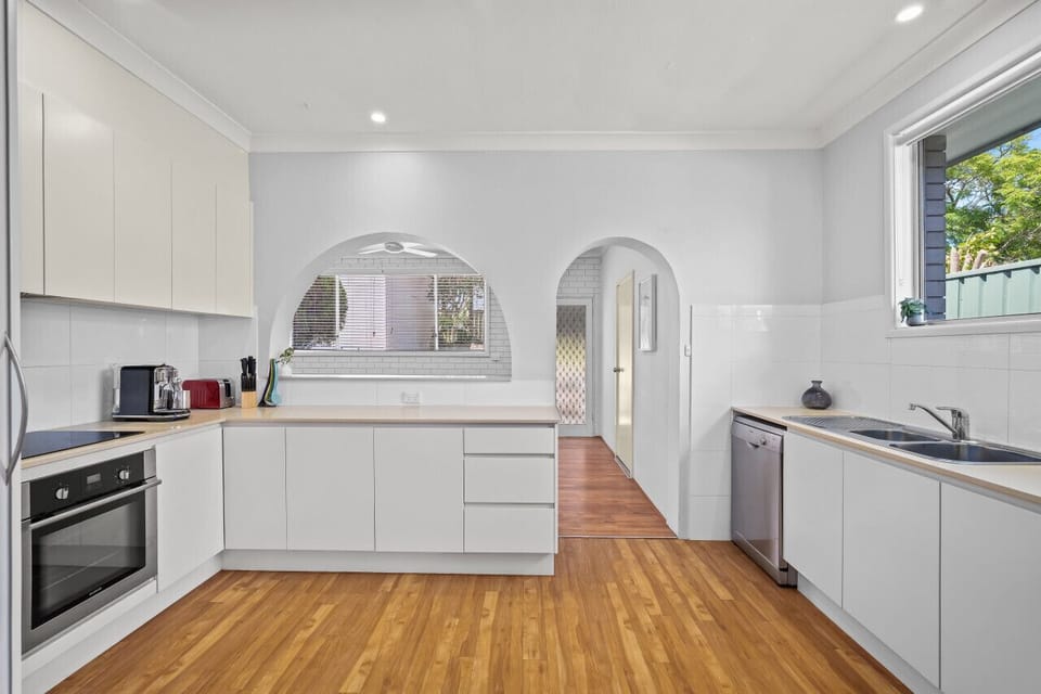 The kitchen is equipped with stainless steel appliances, including a Nespresso coffee machine, and all the necessary cooking amenities.