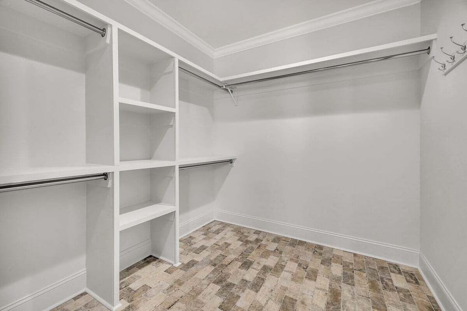 Walk-in closet with shelving and hanging spaces