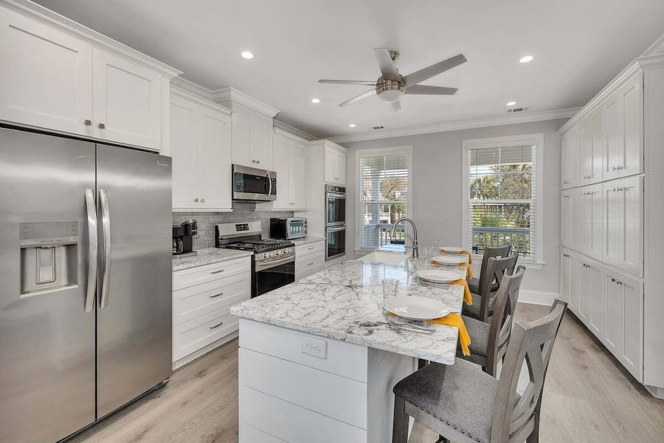 Alternate view of kitchen with stainless steel appliances and island seating
