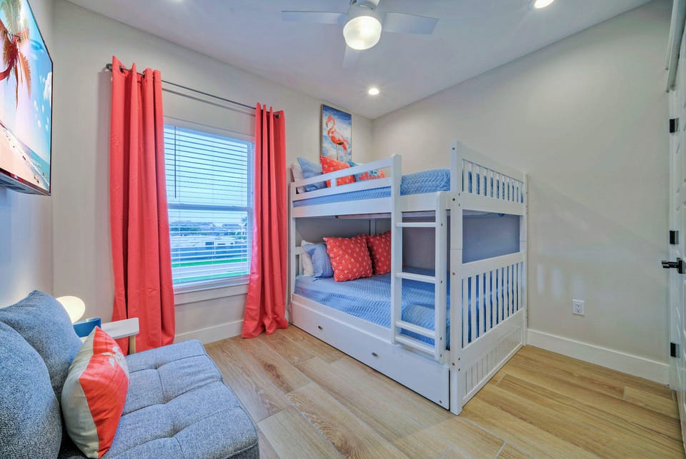 Bedroom 4 features a full-over-full bunk bed, a twin-size trundle, a full-size pullout bed, and a TV.