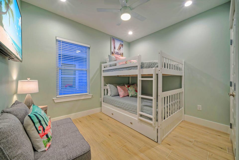 Bedroom 4 features a full-over-full bunk bed, a twin-size trundle, a full-size foldout bed, and a TV.