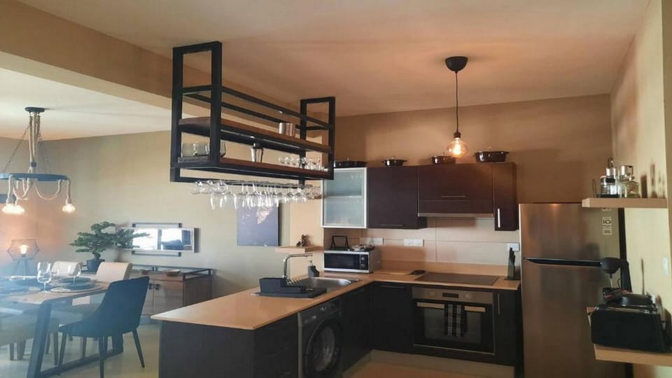 Family Apartment, Pool View | Private kitchen | Coffee/tea maker, full-size fridge, microwave, oven