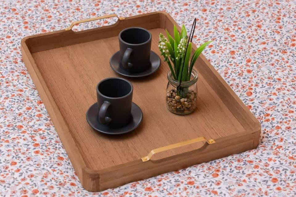 A tray with cups and a decorative plant invites you to enjoy a peaceful coffee break in the comfort of your space.