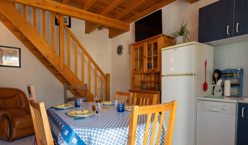 Fully equipped kitchen with dining table, TV, armchair and air conditioning