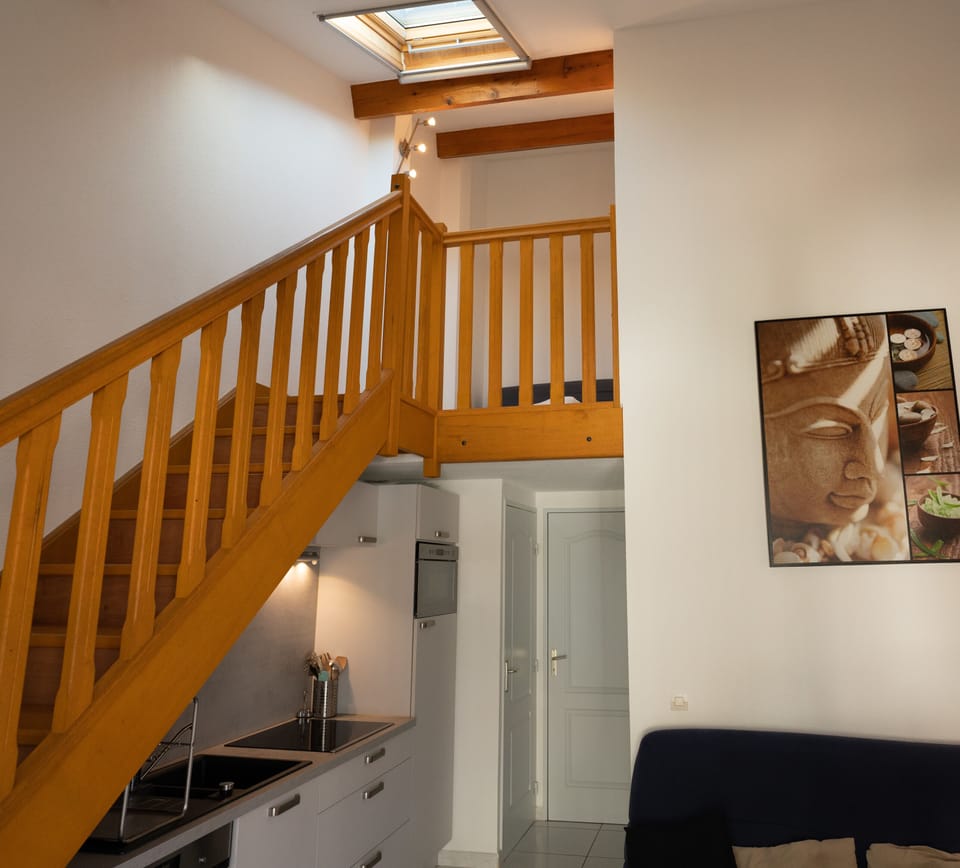 Air-conditioned living room with kitchen, sofa and dining area
