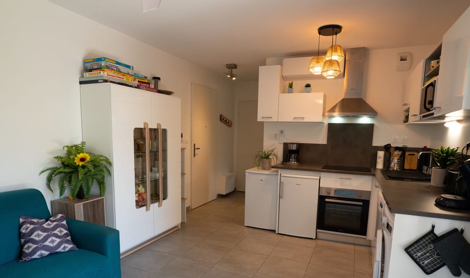 Lounge with TV, dining room and kitchen.