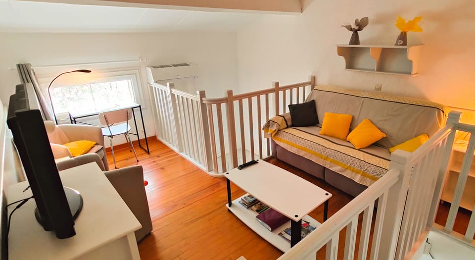 Living room on the mezzanine with study area and television
