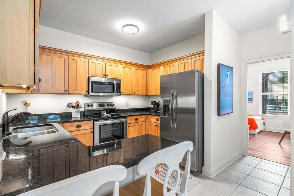 Fully equipped kitchen with sleek appliances and granite countertops
