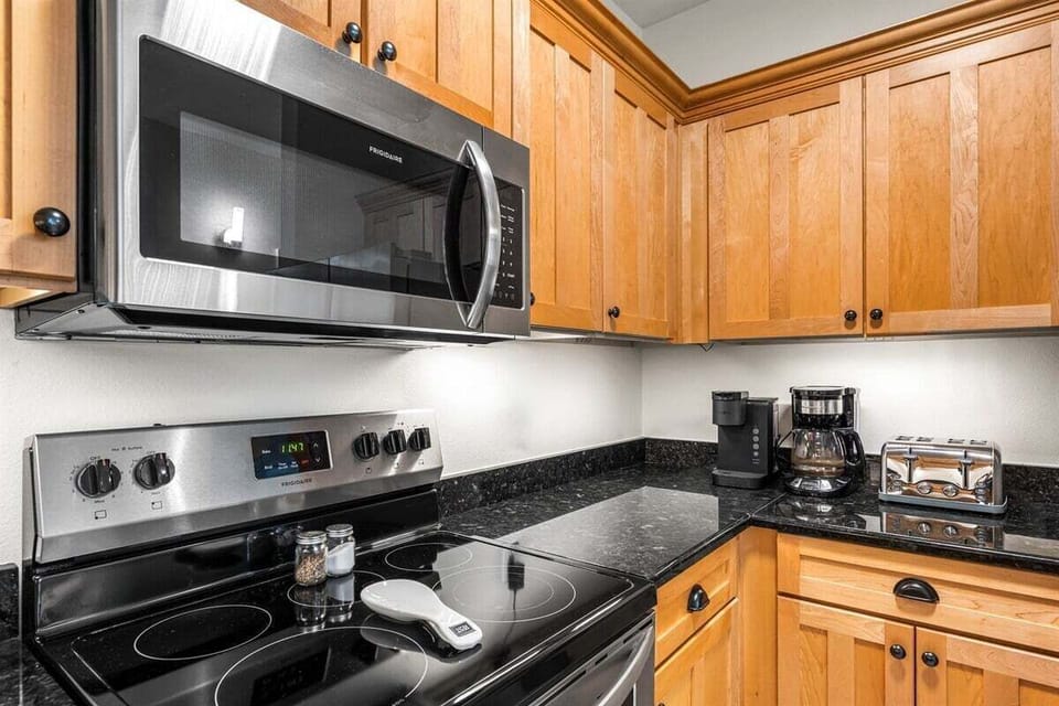 Fully equipped kitchen with sleek appliances and granite countertops