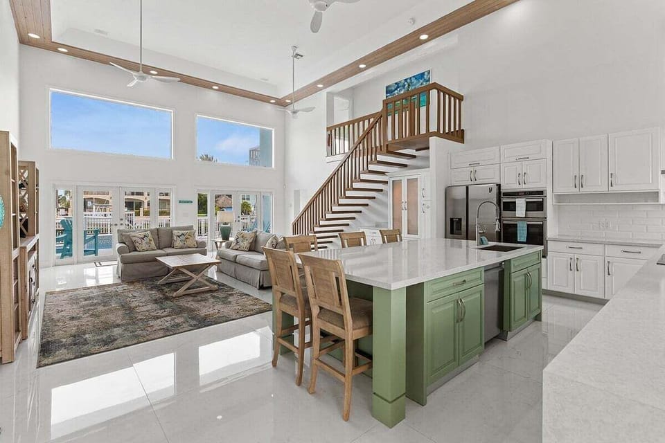 Open concept kitchen, dining, and living room flooded with natural light.