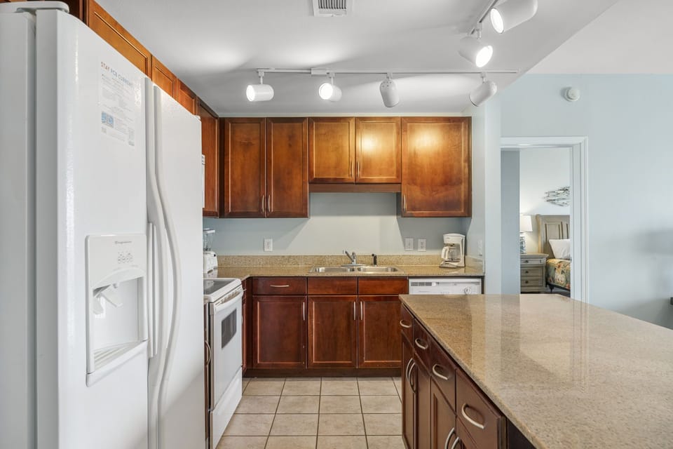 Modern kitchen with granite countertops and wooden cabinetry