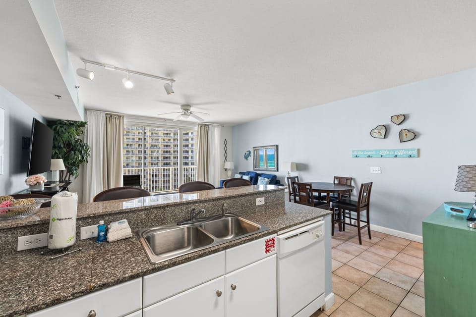 Bright, open-concept living space with modern kitchen, dining area, and ocean views—ideal for gathering with loved ones or unwinding after a day at the beach.