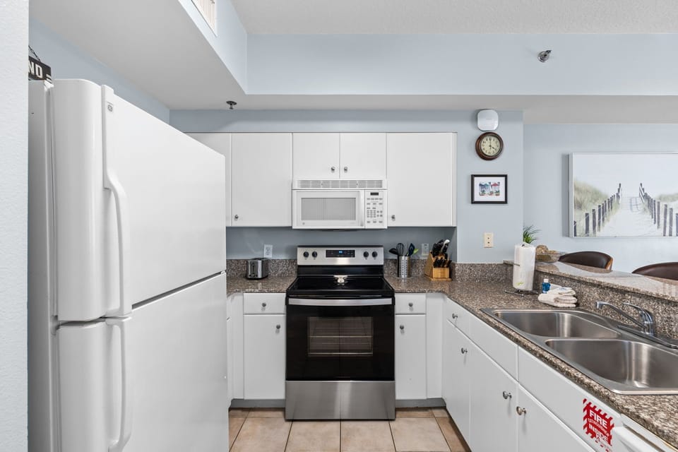 Your fully equipped kitchen features modern appliances, granite countertops, and a bright, airy design—perfect for preparing meals or morning coffee during your stay.