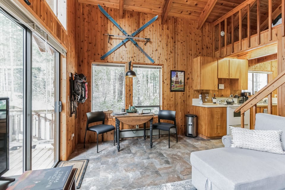 Dining area with wood paneling and cabin decor.