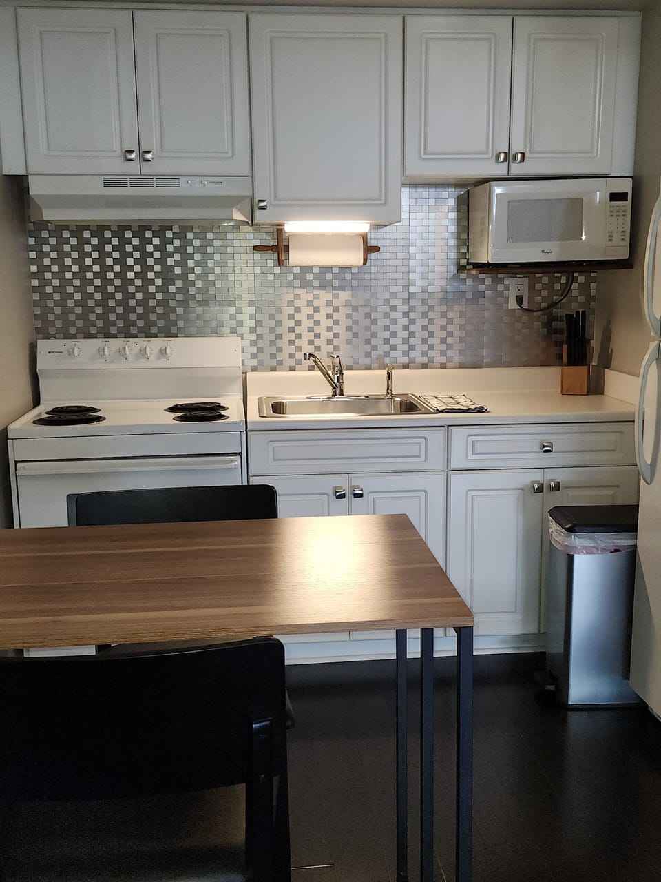 Fully stocked kitchen with four-burner stove / oven.
