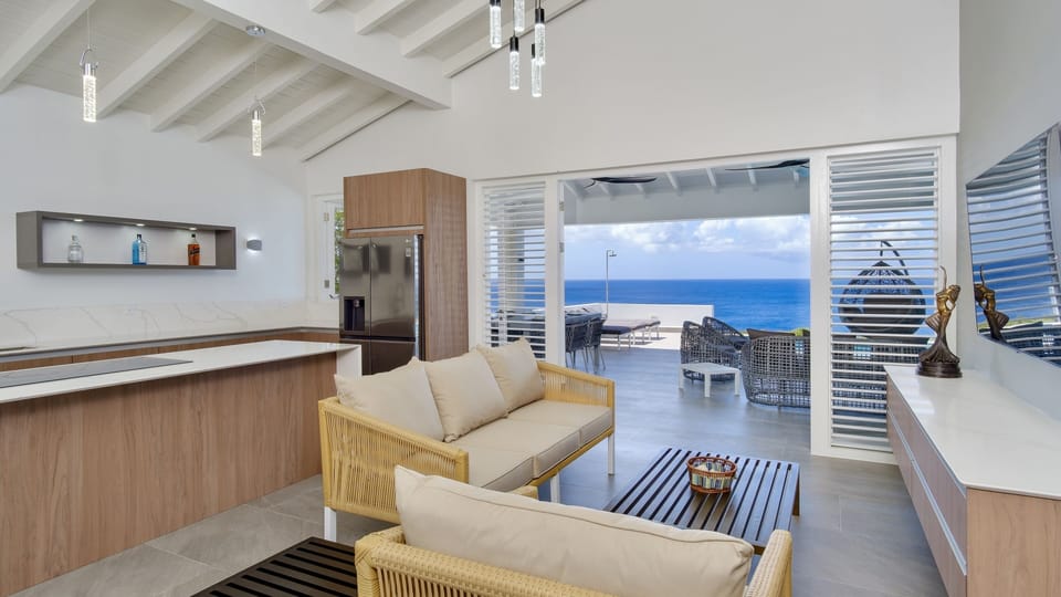 Large  kitchen opens to living and dinning room with ocean views top appliances 