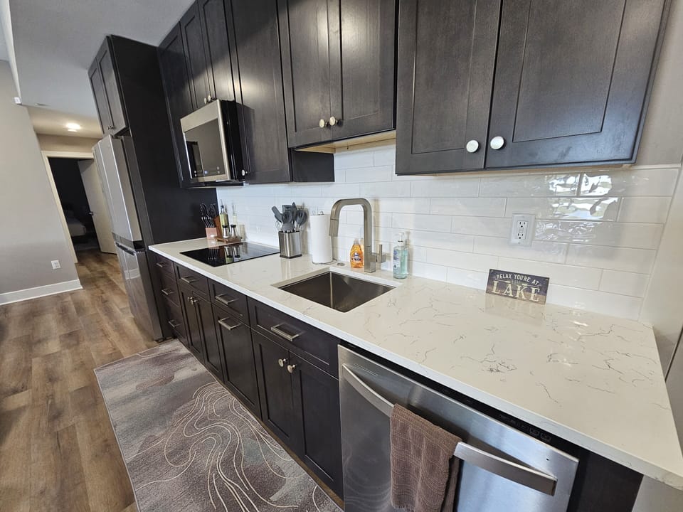 Kitchen w/microwave, induction cooktop, full size fridge/freezer and dishwasher