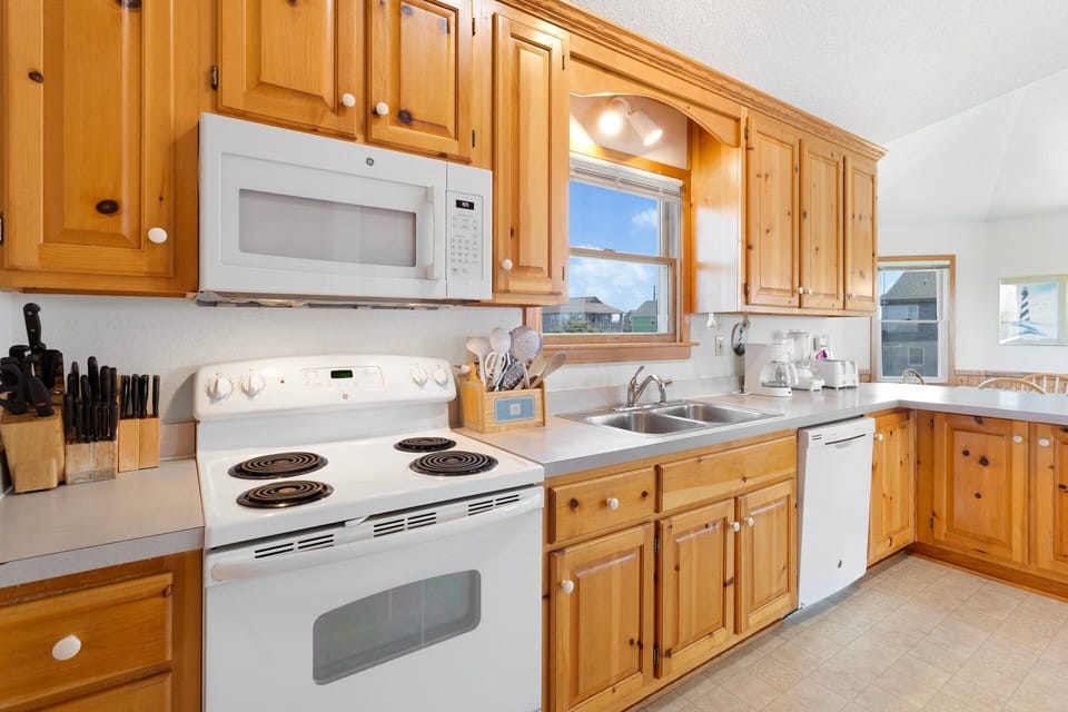 Kitchen: Modern Kitchen with stainless appliances, ample counter space, and an espresso machine.