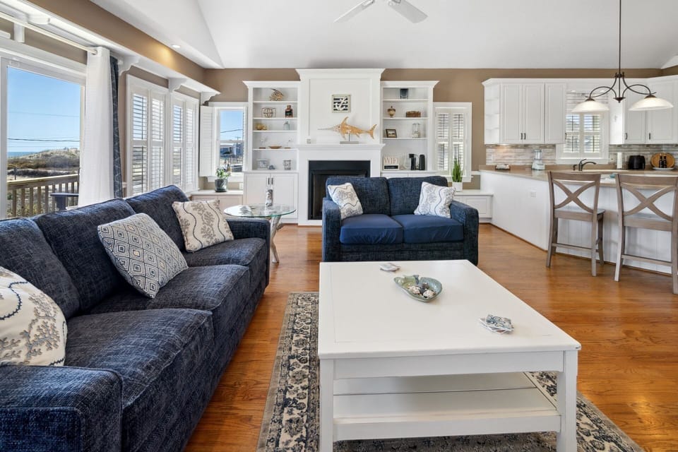 The spacious Living Area with a Flat Screen TV and views of the ocean is your dream home base!
