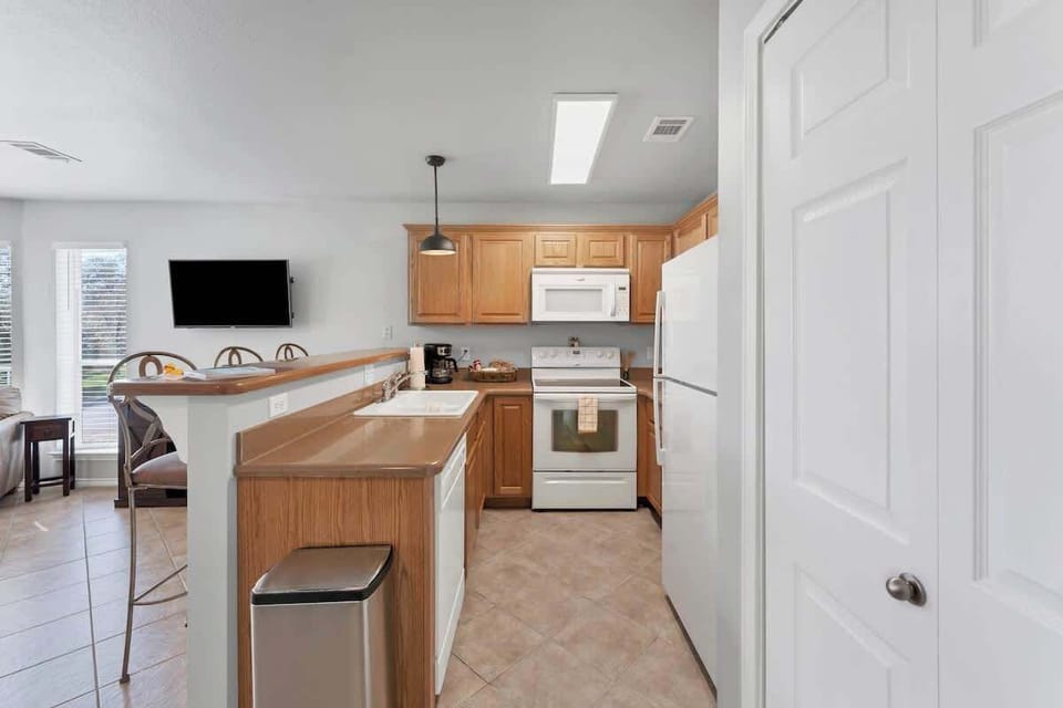 Bright, open kitchen is fully stocked with everything you need to feed large group!