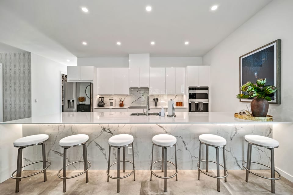 Gather around the kitchen island breakfast bar—perfect for morning coffee, casual bites, or sharing laughs while meals sizzle nearby.