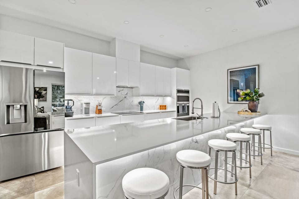 Step into a chef's dream kitchen where the sleek island anchors the space, inviting conversation, connection, and culinary creativity.